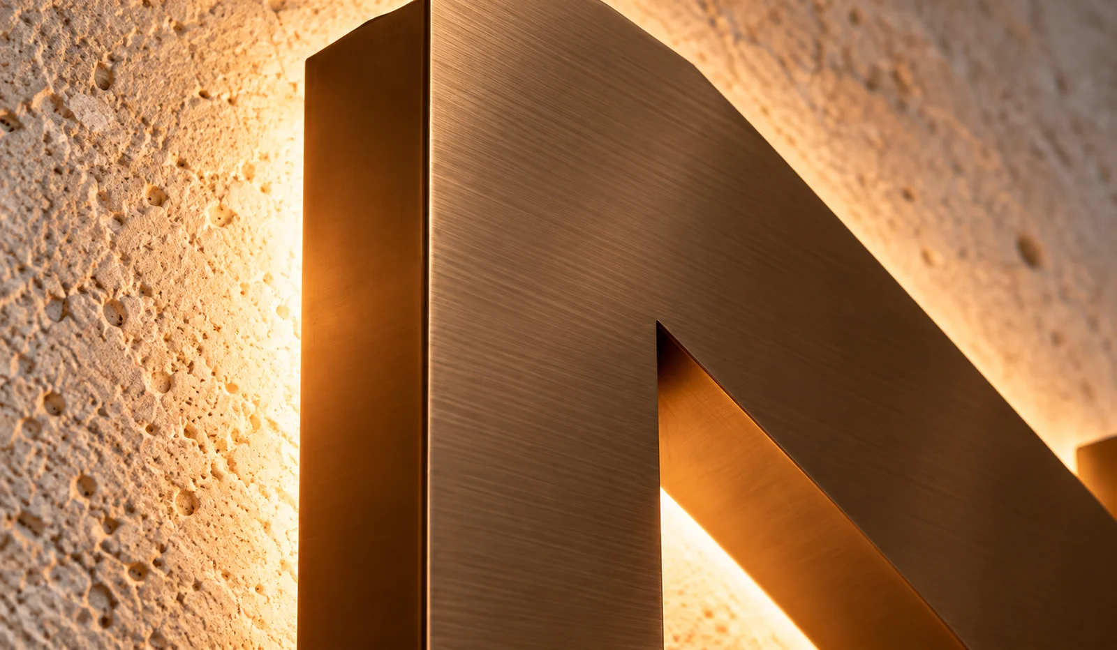 Brushed bronze letter face with a warm halo — appearance concept