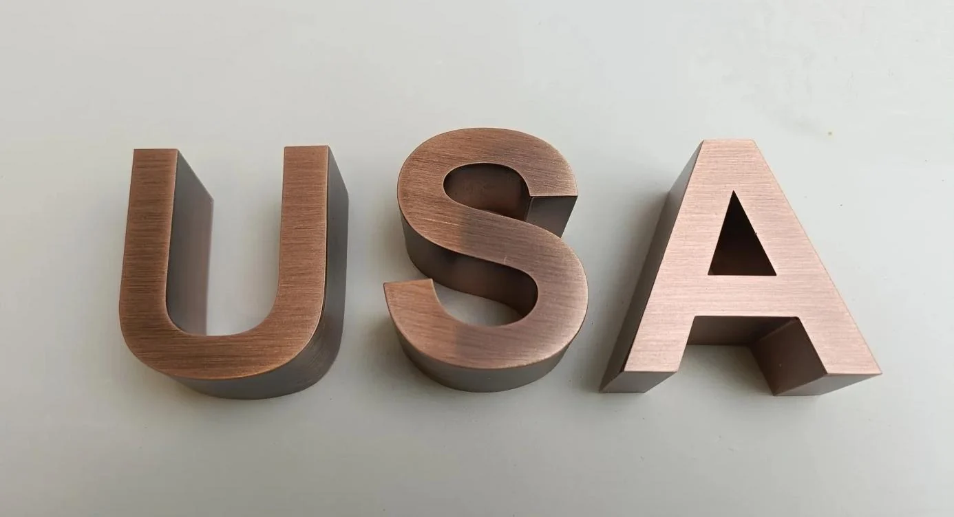 Brushed metal letter samples showing faces and formed dimensional returns