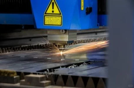 Laser cutting a metal sheet for sign fabrication
